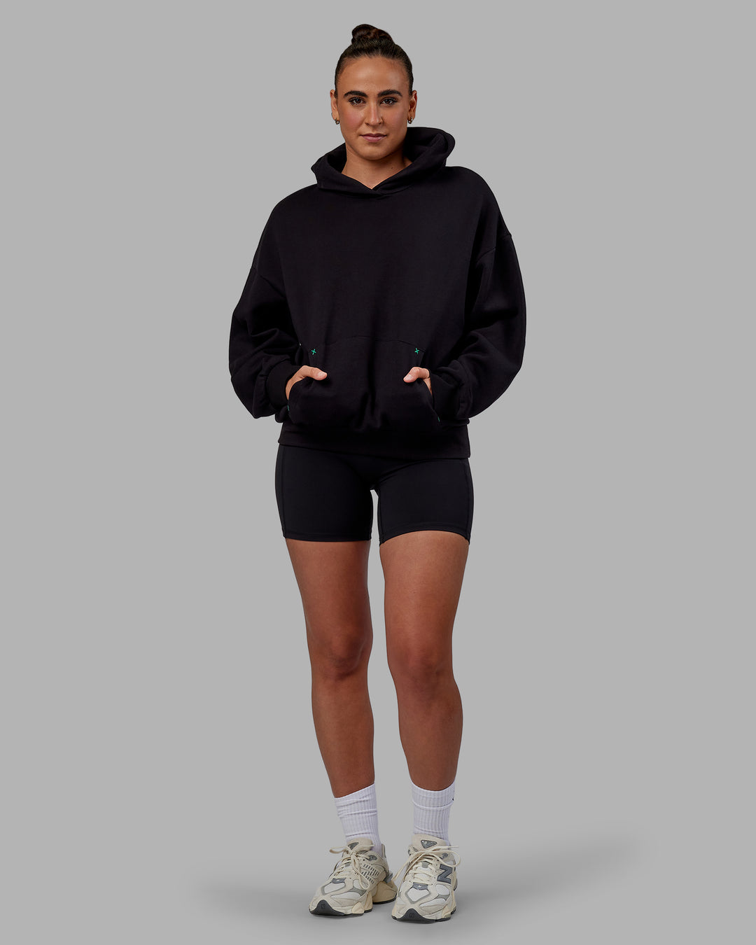 Woman wearing Unisex We Rise Hoodie Oversize - Black-Impact Green - view 10