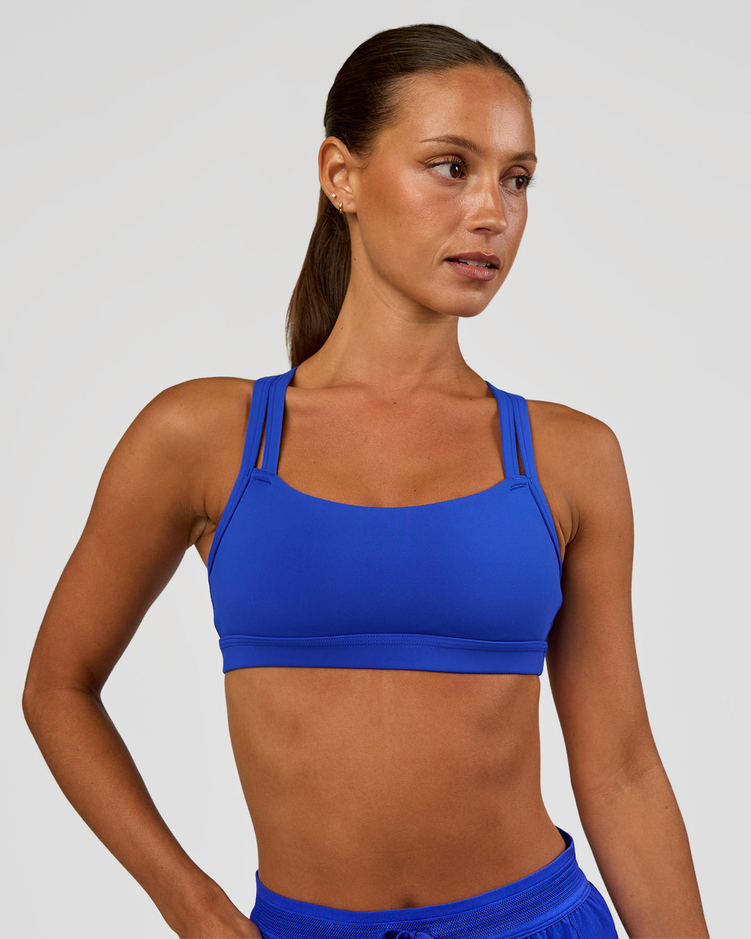 Woman wearing Velocity Sports Bra - Electric Indigo | Model:Brylee | Size:XS - view 3