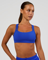Woman wearing Velocity Sports Bra - Electric Indigo | Model:Brylee | Size:XS | Thumbnail Index: 2