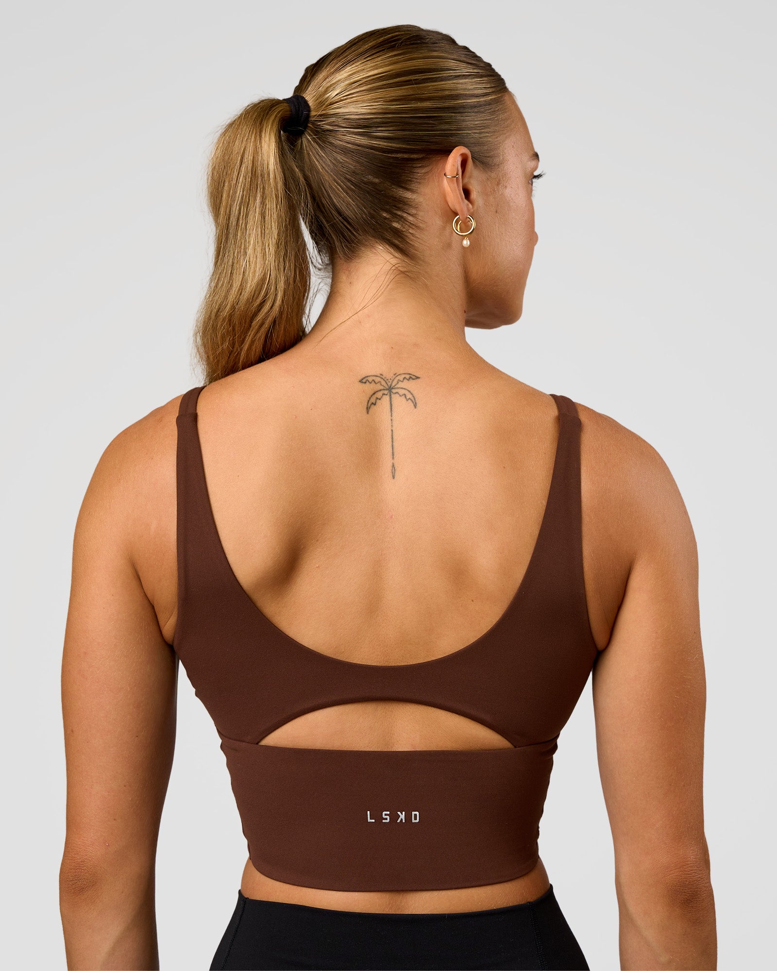 Woman wearing Vitality Long Line Sports Bra - Hot Chocolate | Model:Maja | Size:XS