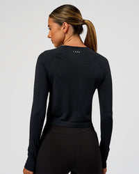 Woman wearing AeroFLX+ Seamless Long Sleeve Skimmer Tee - Black Marl | Model:Charli | Size:XS | Thumbnail Index: 6