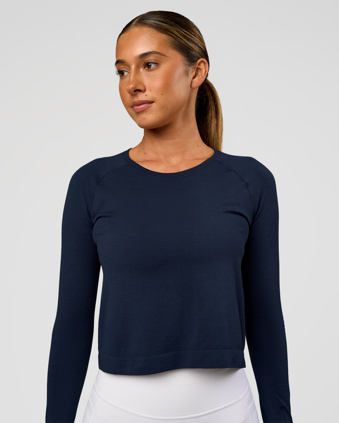 Woman wearing AeroFLX+ Seamless Long Sleeve Skimmer Tee - Future Navy/Future Navy | Model:Charli | Size:XS - view 2