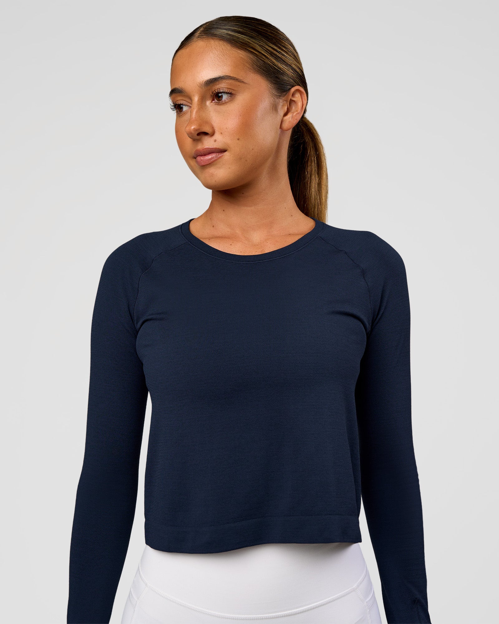 Woman wearing AeroFLX+ Seamless Long Sleeve Skimmer Tee - Future Navy/Future Navy | Model:Charli | Size:XS