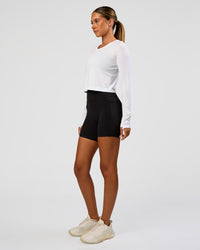 Woman wearing AeroFLX+ Seamless Long Sleeve Skimmer Tee - White/White | Model:Charli | Size:XS | Thumbnail Index: 7
