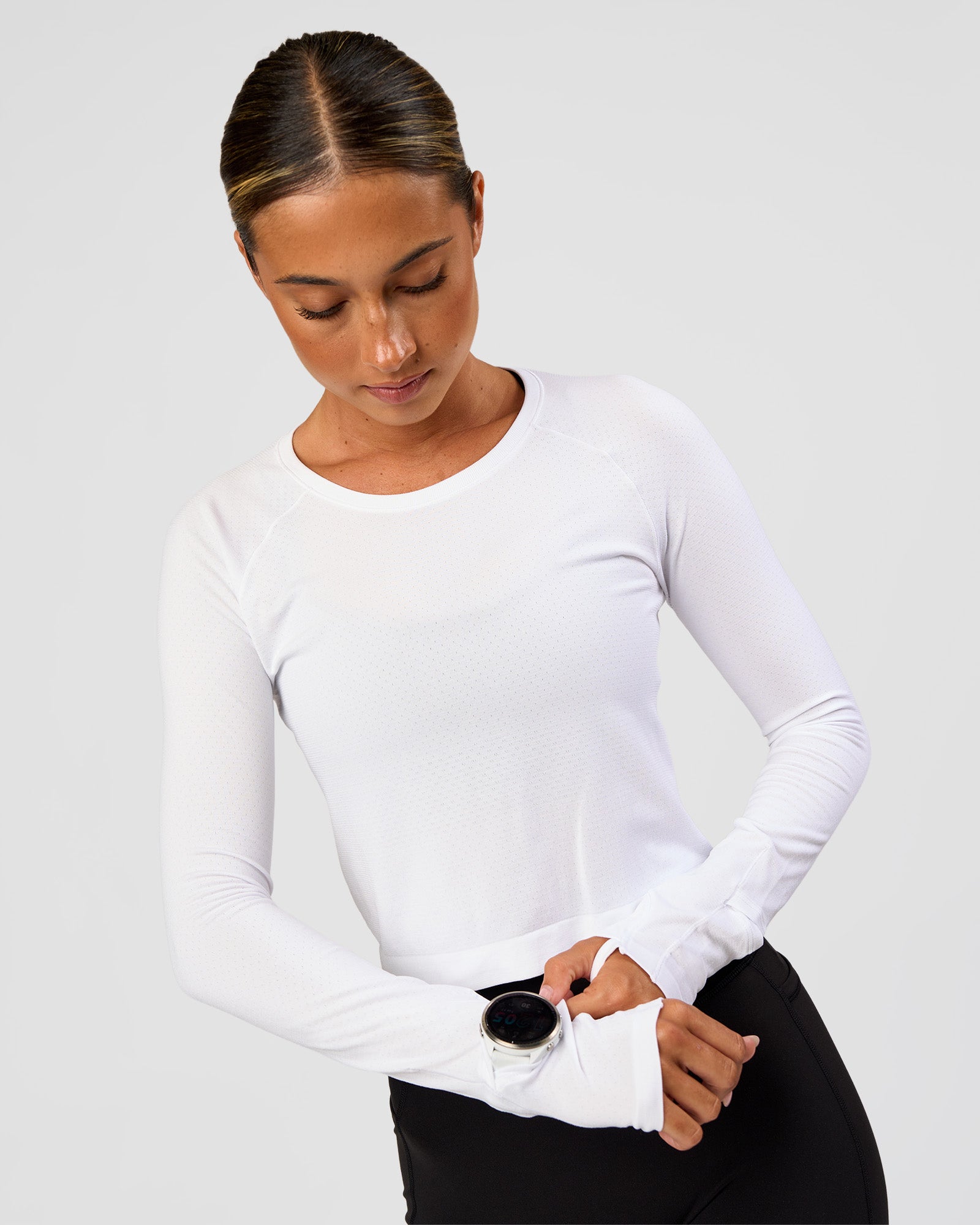 Woman wearing AeroFLX+ Seamless Long Sleeve Skimmer Tee - White/White | Model:Charli | Size:XS