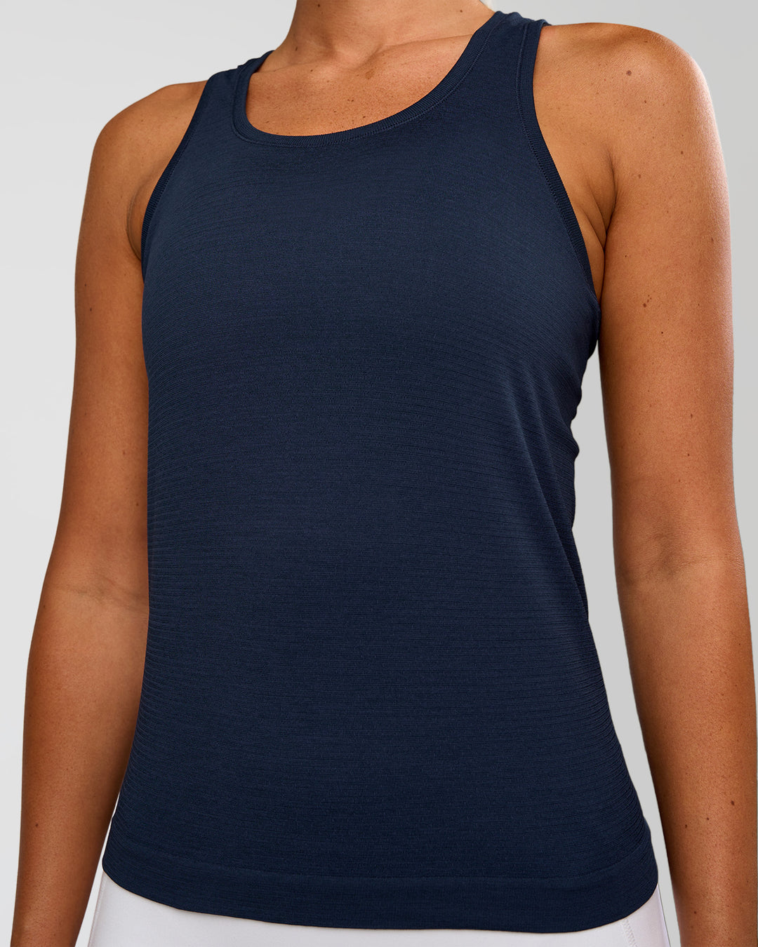 Woman wearing AeroFLX+ Seamless Tank - Future Navy/Future Navy | Model:Charli | Size:XS - view 4
