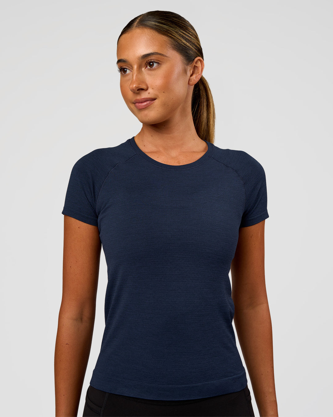Woman wearing AeroFLX+ Seamless Tee - Future Navy/Future Navy | Model:Charli | Size:XS - view 1