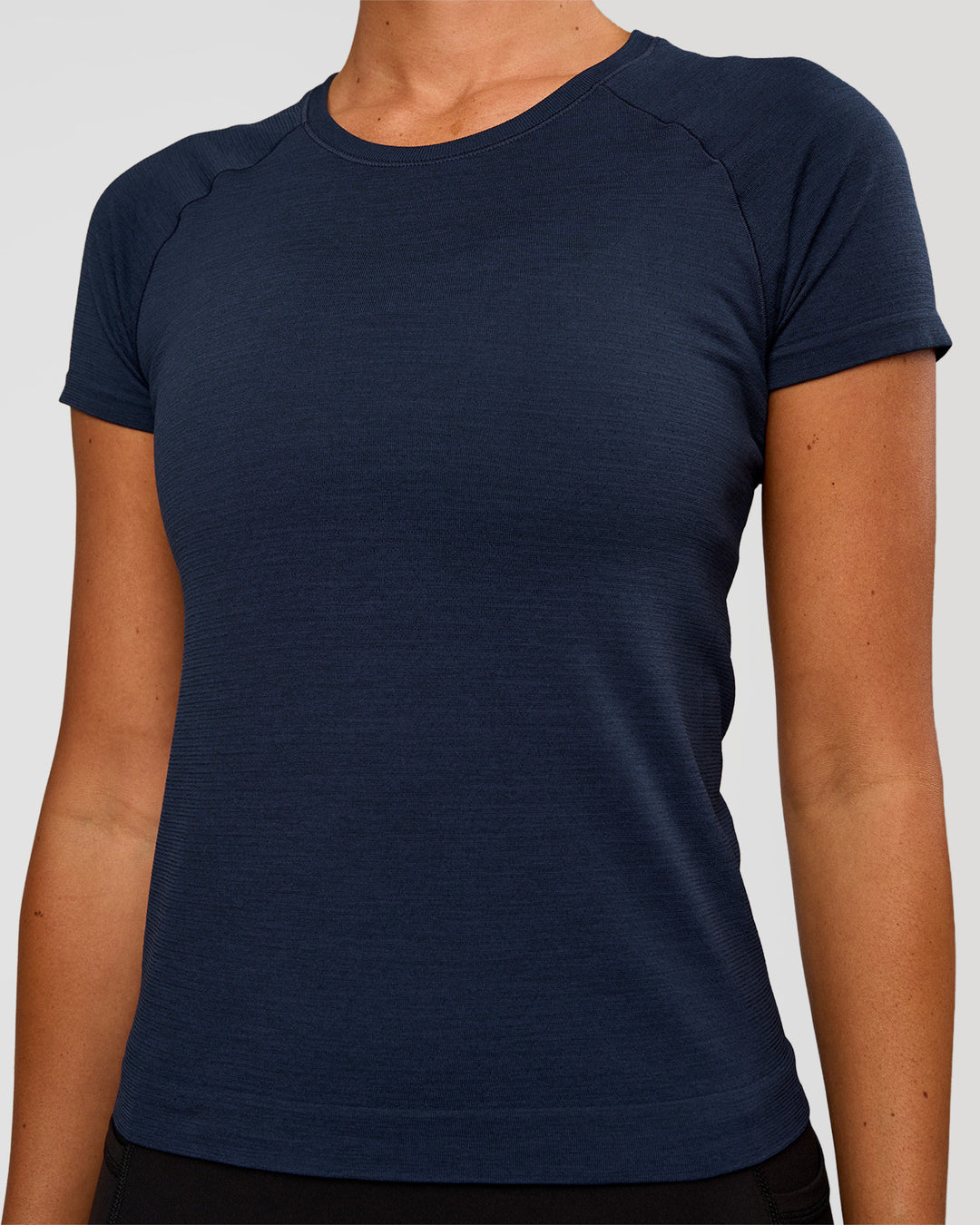 Woman wearing AeroFLX+ Seamless Tee - Future Navy/Future Navy | Model:Charli | Size:XS - view 4