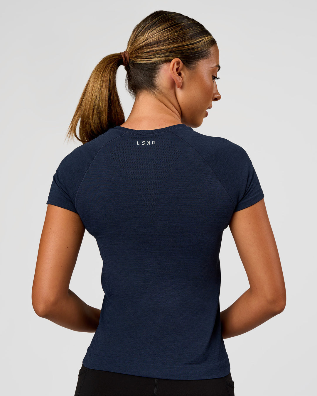 Woman wearing AeroFLX+ Seamless Tee - Future Navy/Future Navy | Model:Charli | Size:XS - view 6
