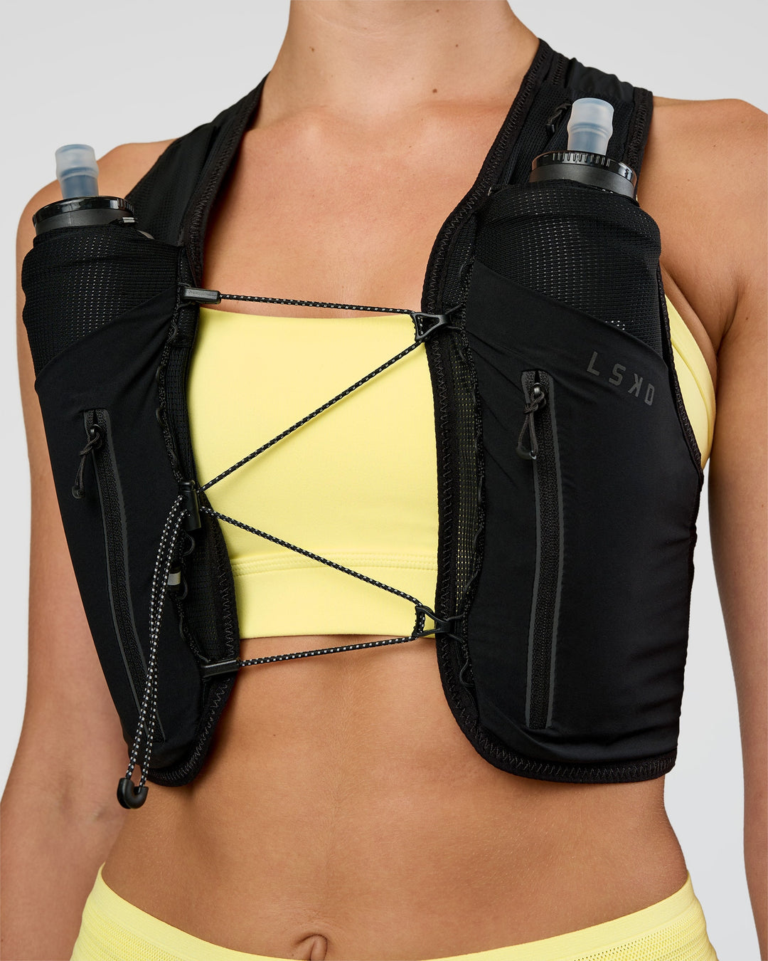 Woman wearing Pace Running Vest - Black-Reflective | Model:Evie | Size:XS/S - view 12
