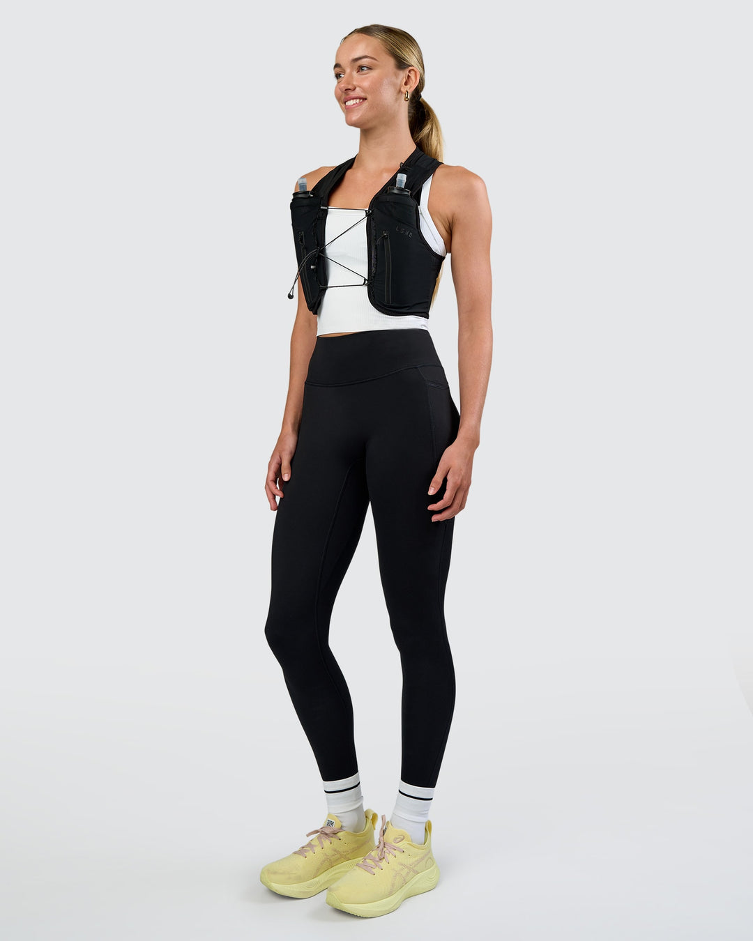 Woman wearing Pace Running Vest - Black-Reflective | Model:Evie | Size:XS/S - view 6