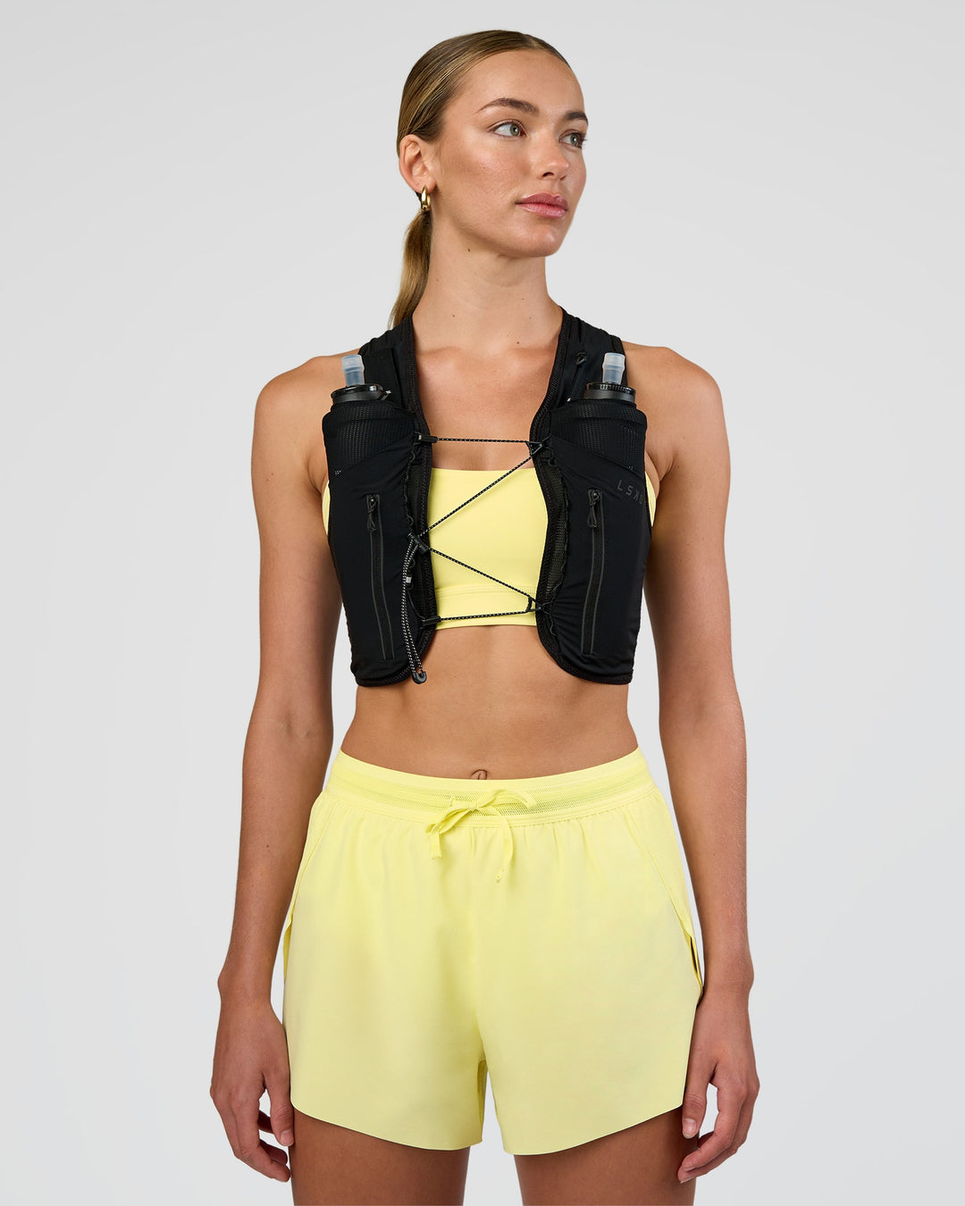 Woman wearing Pace Running Vest - Black-Reflective | Model:Evie | Size:XS/S - view 5