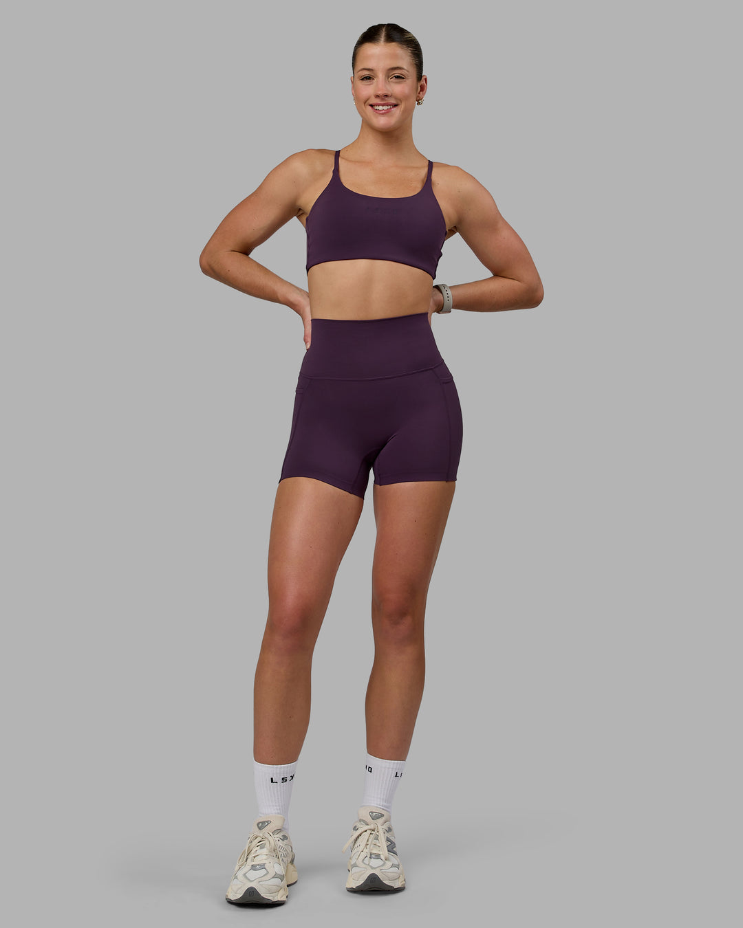 Woman wearing Twist Sports Bra - Midnight Plum - view 4