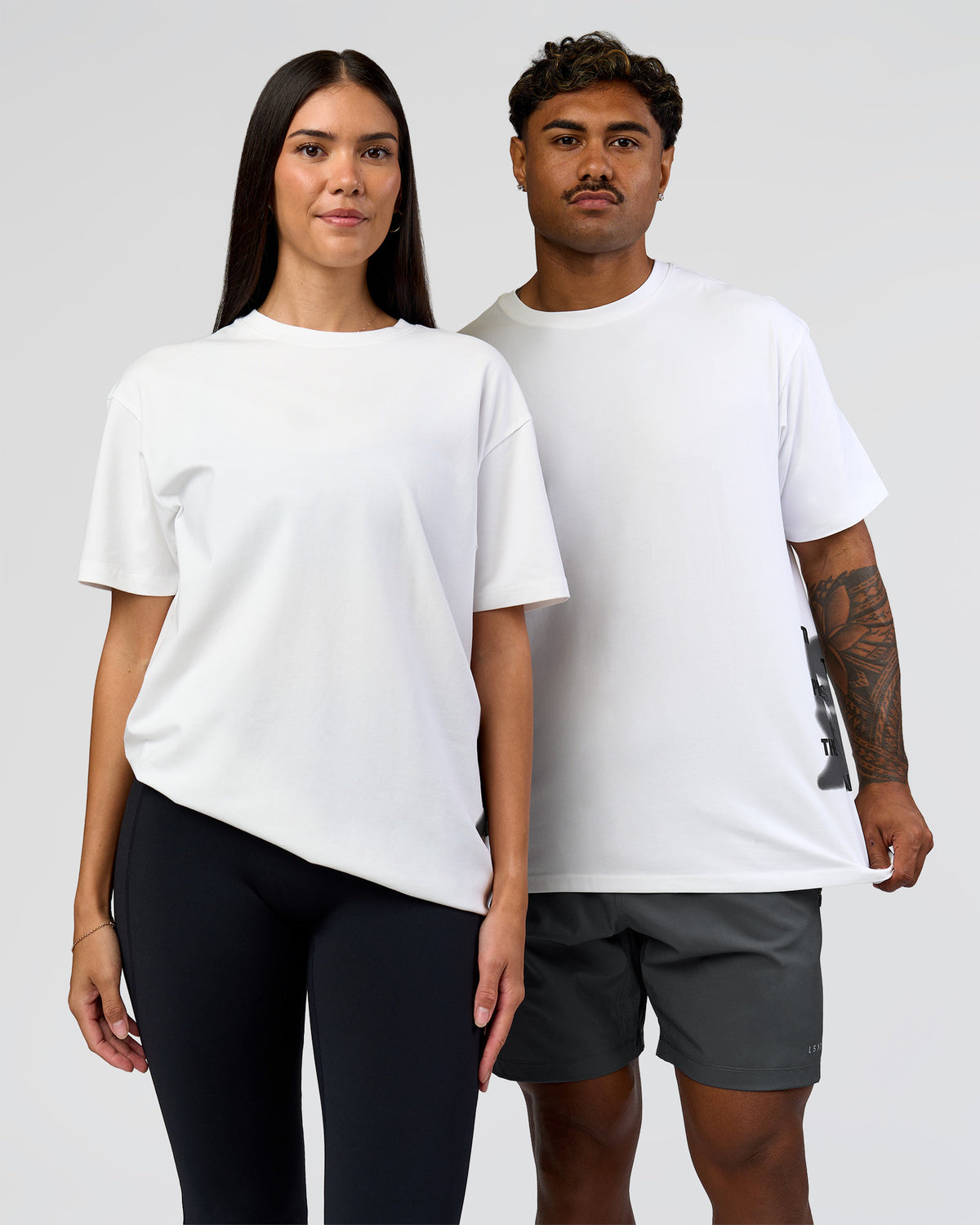 Duo wearing Clear Vision Heavyweight FLXCotton Oversized Tee - White-Black | Model:Xav | Size:L | Model:Rhiley | Size:XS