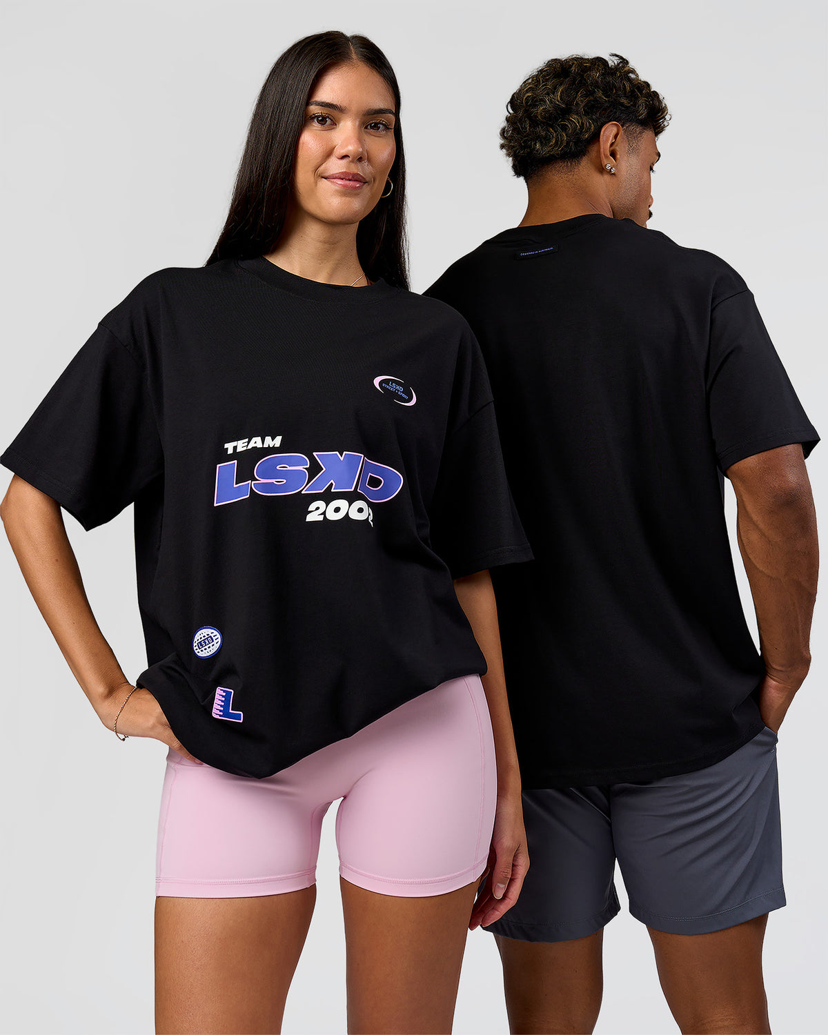 Duo wearing League Heavyweight FLXCotton Oversized Tee - Black-Power Cobalt | Model:Xav | Size:L | Model:Rhiley | Size:XS