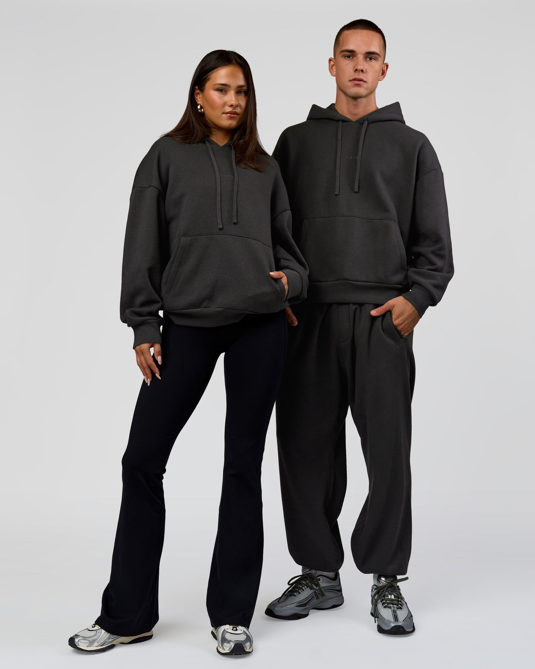 Duo wearing Base Oversized DC Hoodie - Onyx | Model:Albert | Size:M | Model:Bianca | Size:XS - view 4