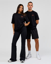 Duo wearing Coffee Run FLXCotton Oversized Tee - Black-Ultra Orange | Model:Albert | Size:M | Model:Bianca | Size:XS | Thumbnail Index: 4