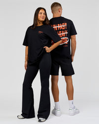 Duo wearing Coffee Run FLXCotton Oversized Tee - Black-Ultra Orange | Model:Albert | Size:M | Model:Bianca | Size:XS | Thumbnail Index: 0