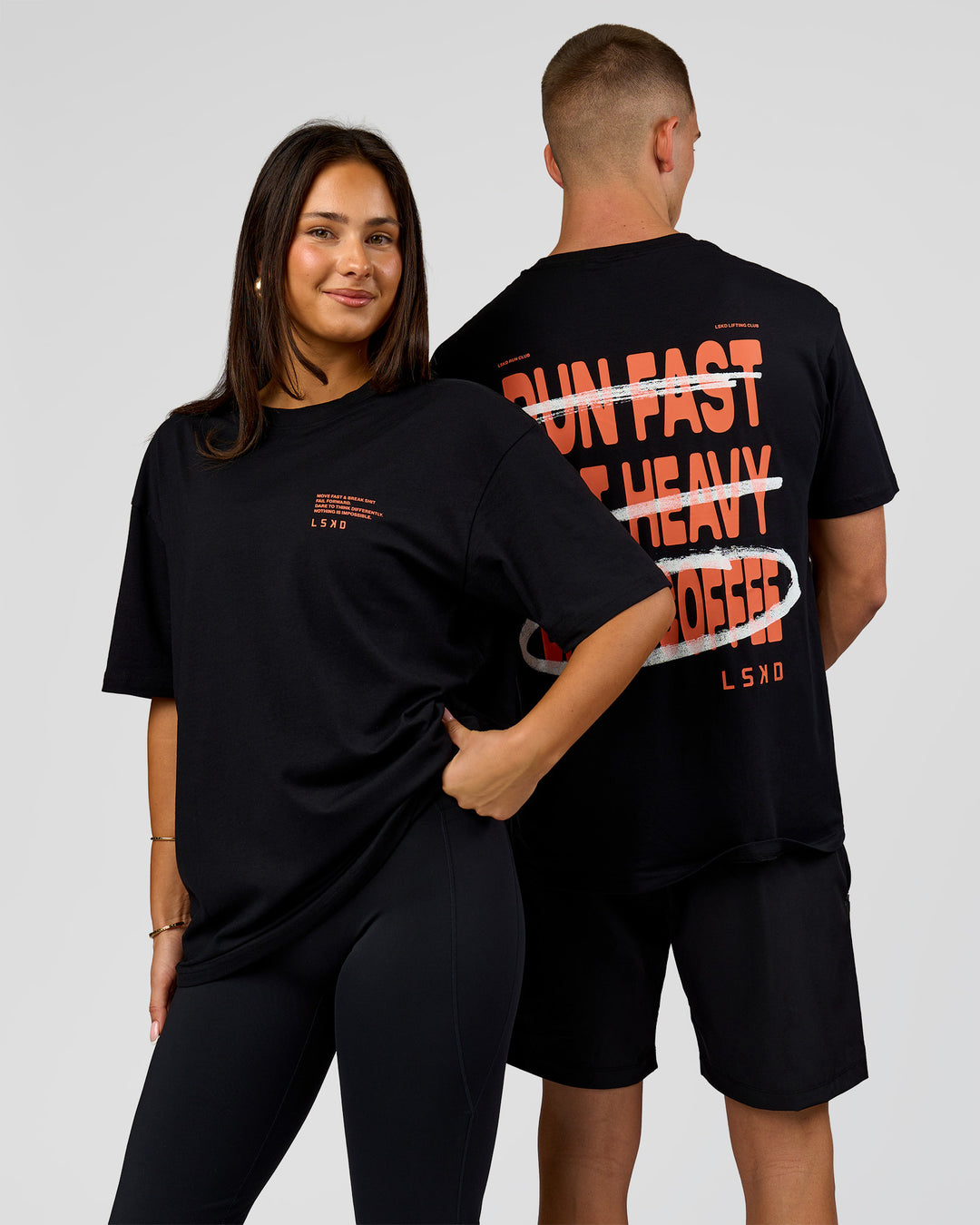 Duo wearing Coffee Run FLXCotton Oversized Tee - Black-Ultra Orange | Model:Albert | Size:M | Model:Bianca | Size:XS - view 10