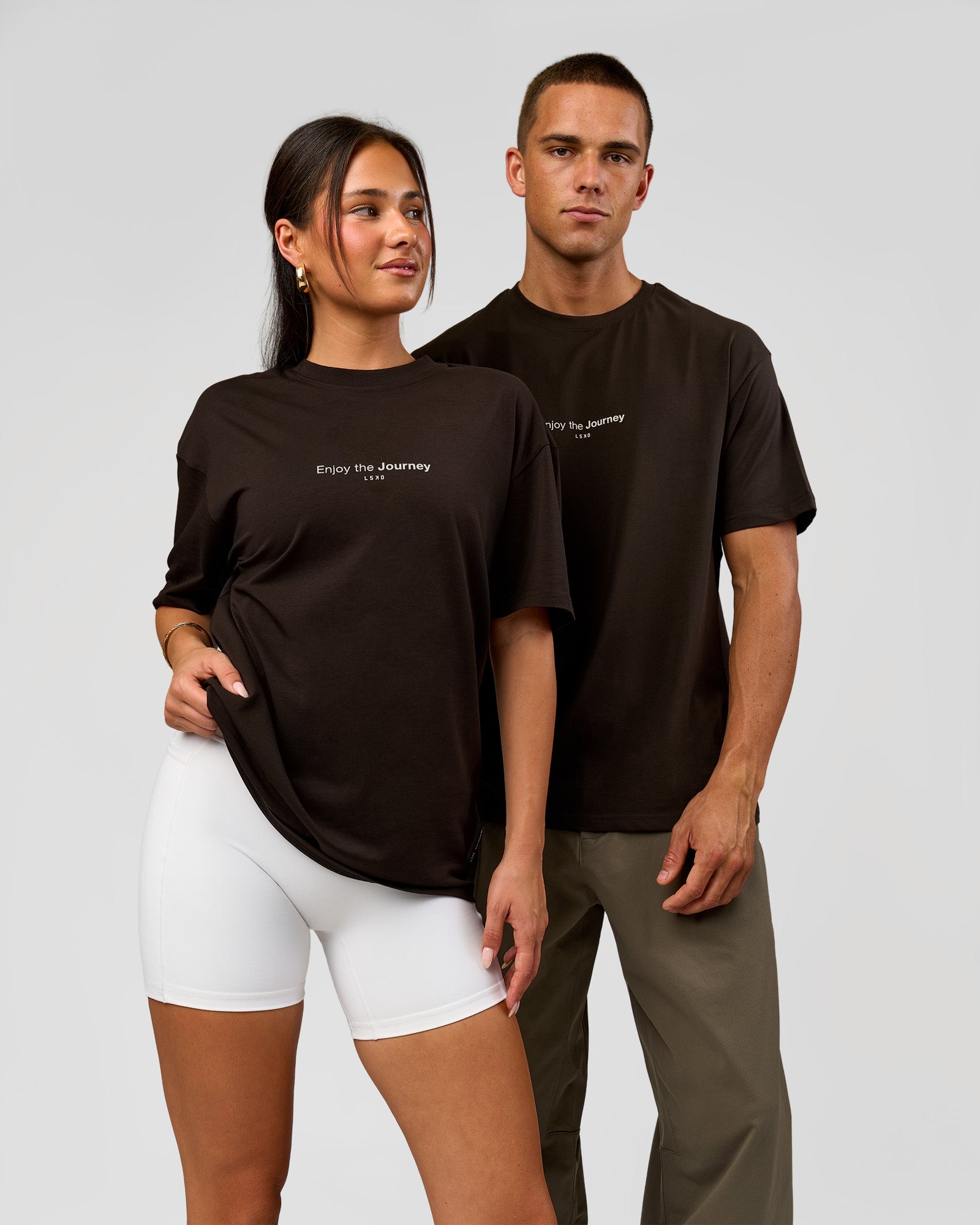 Duo wearing VS1 Enjoy The Journey FLXCotton Oversize Tee - Ground Coffee | Model:Albert | Size:M | Model:Bianca | Size:XS