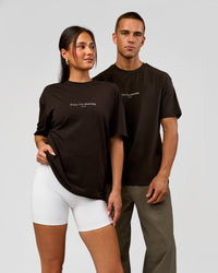 Duo wearing VS1 Enjoy The Journey FLXCotton Oversize Tee - Ground Coffee | Model:Albert | Size:M | Model:Bianca | Size:XS | Thumbnail Index: 0