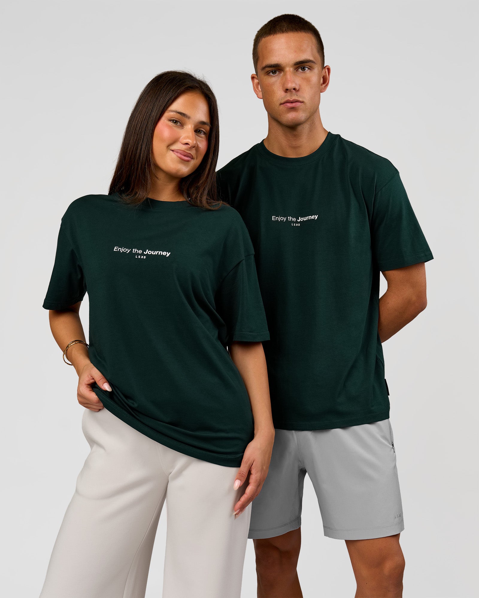 Duo wearing VS1 Enjoy The Journey FLXCotton Oversize Tee - Midnight Green | Model:Albert | Size:M | Model:Bianca | Size:XS