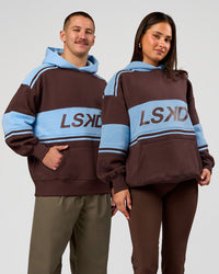 Duo wearing A-Team Oversized Hoodie - Hot Chocolate-Open Air | Model:Bianca | Size:S | Model:Jaiden | Size:L | Thumbnail Index: 0