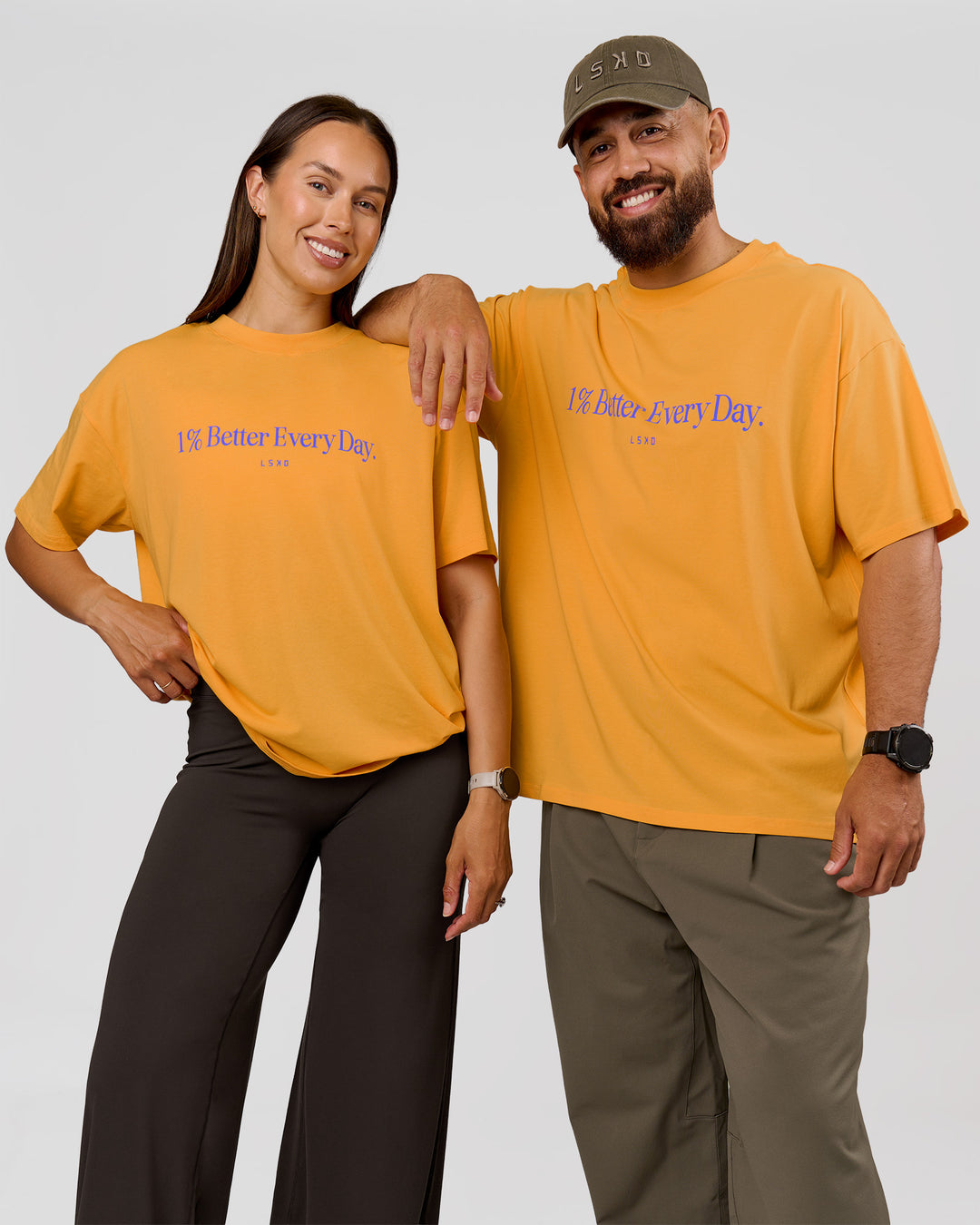 Duo wearing VS6 1% Better Fathers Day FLXCotton Oversized Tee - Warm Apricot | Model:Jess | Size:S | Model:Jordan | Size:XL - view 1