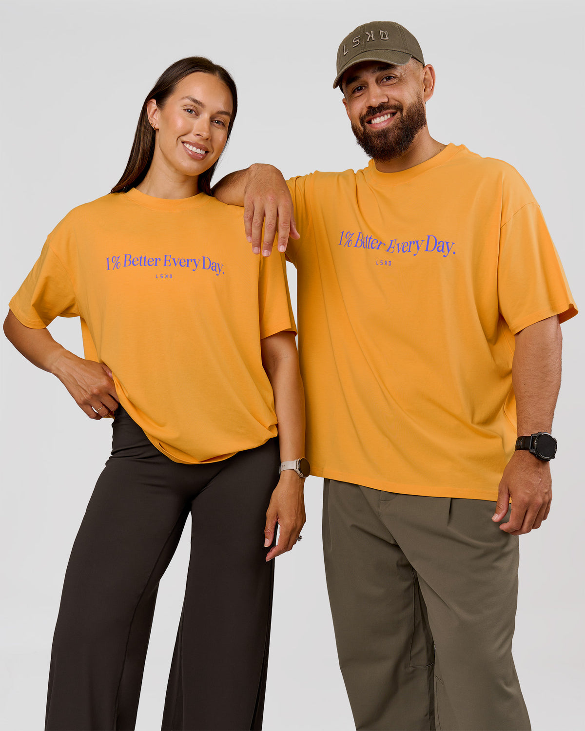 Duo wearing VS6 1% Better Fathers Day FLXCotton Oversized Tee - Warm Apricot | Model:Jess | Size:S | Model:Jordan | Size:XL
