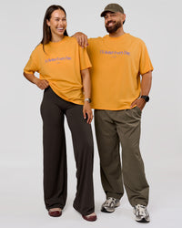 Duo wearing VS6 1% Better Fathers Day FLXCotton Oversized Tee - Warm Apricot | Model:Jess | Size:S | Model:Jordan | Size:XL | Thumbnail Index: 3