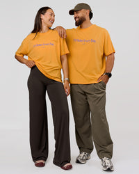 Duo wearing VS6 1% Better Fathers Day FLXCotton Oversized Tee - Warm Apricot | Model:Jess | Size:S | Model:Jordan | Size:XL | Thumbnail Index: 6