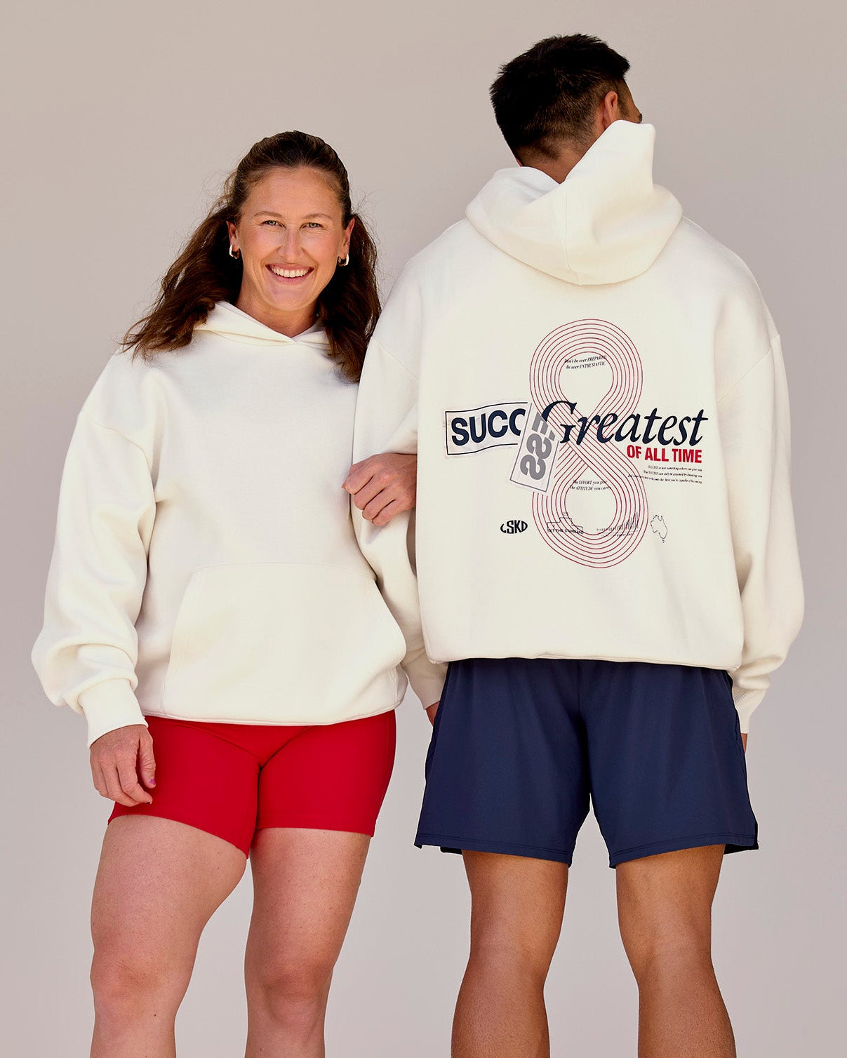Duo wearing Greatest of All Time Heavyweight Oversized Hoodie - Off White | Model:Tia | Size:S | Model:Shane | Size:L