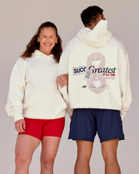 Duo wearing Greatest of All Time Heavyweight Oversized Hoodie - Off White | Model:Tia | Size:S | Model:Shane | Size:L | Thumbnail Index: 0