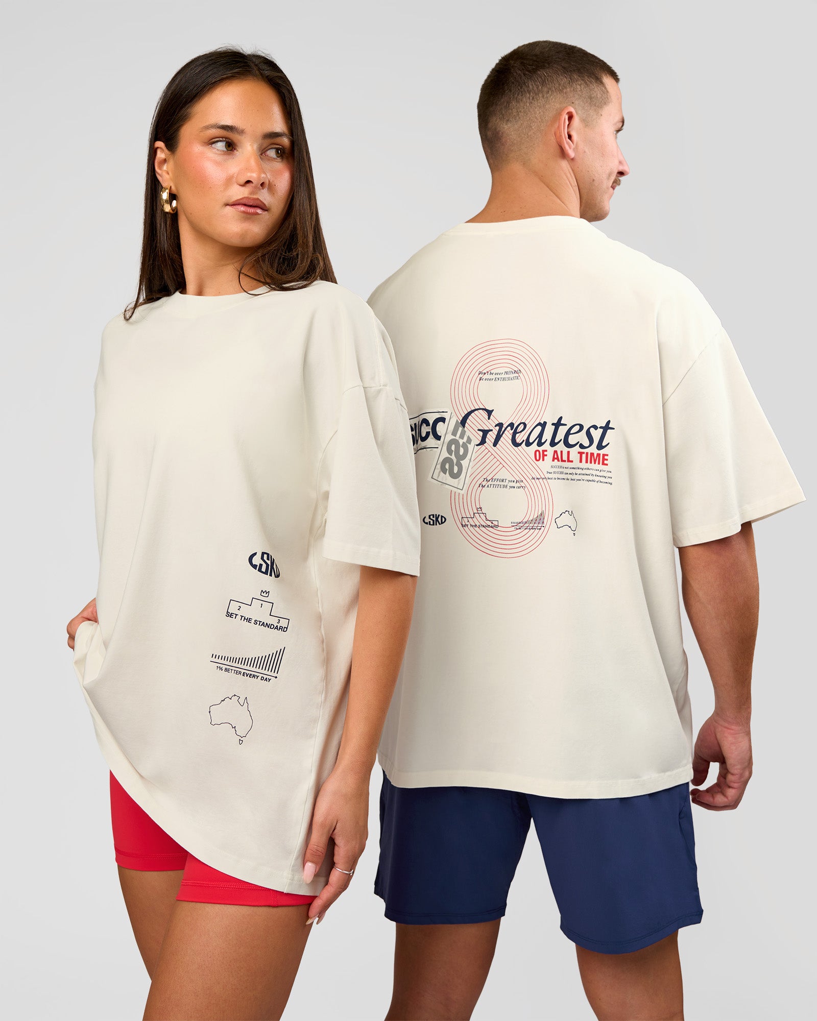 Duo wearing Greatest of All Time Heavyweight FLXCotton Oversized Tee - Off White Washed-Scarlet | Model:Bianca | Size:XS | Model:Jaiden | Size:L