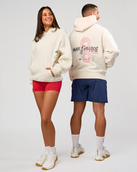 Duo wearing Greatest of All Time Heavyweight Oversized Hoodie - Off White | Model:Bianca | Size:XS | Model:Jaiden | Size:L | Thumbnail Index: 1