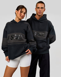Duo wearing A-Team Oversized Hoodie - Caviar-Onyx | Model:Bianca | Size:XS | Model:Albert | Size:M | Thumbnail Index: 0