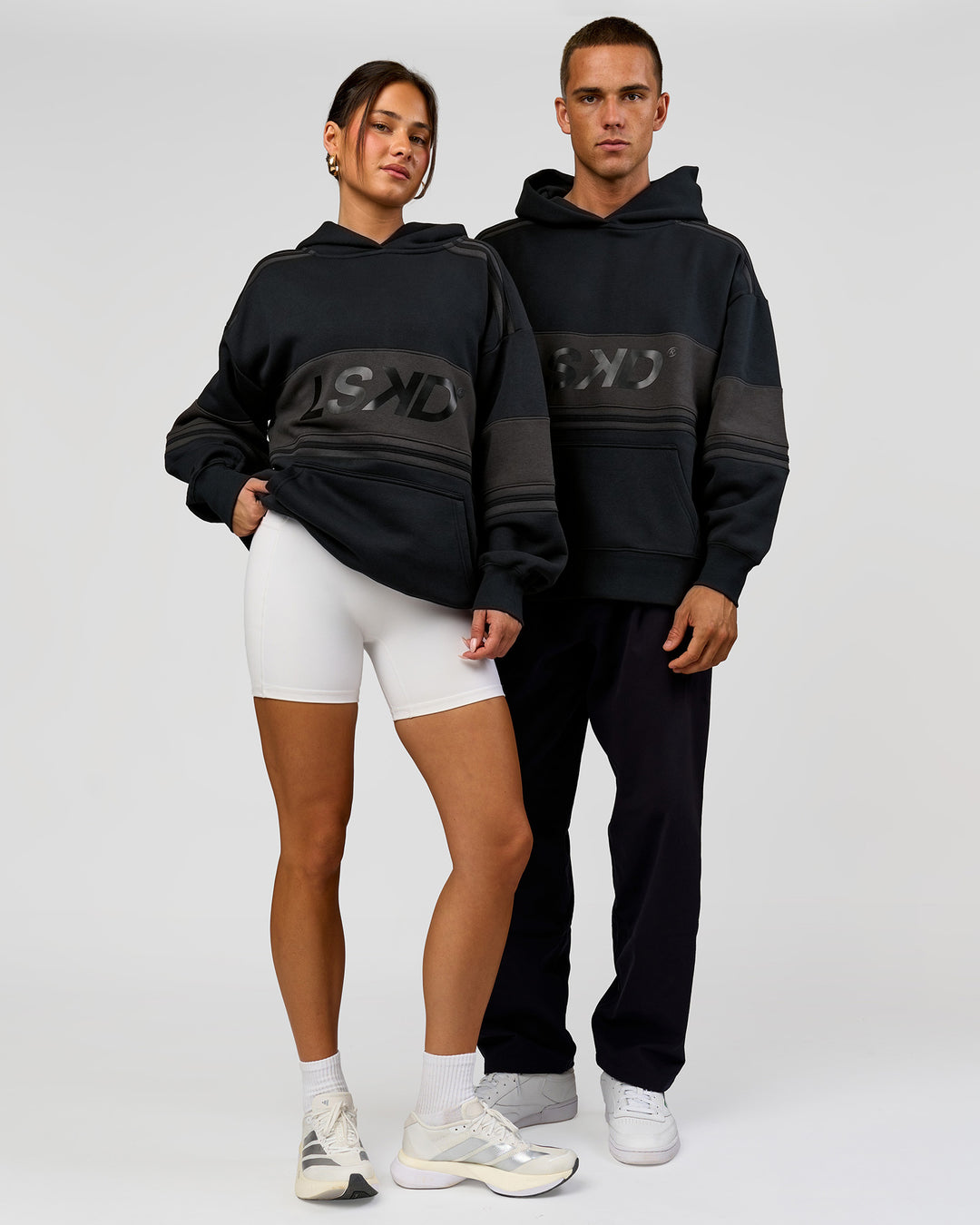 Duo wearing A-Team Oversized Hoodie - Caviar-Onyx | Model:Bianca | Size:XS | Model:Albert | Size:M - view 2
