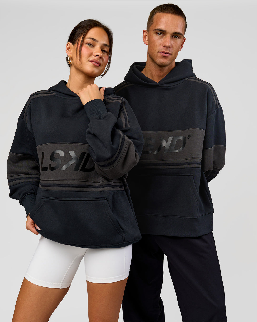 Duo wearing A-Team Oversized Hoodie - Caviar-Onyx | Model:Bianca | Size:XS | Model:Albert | Size:M - view 3