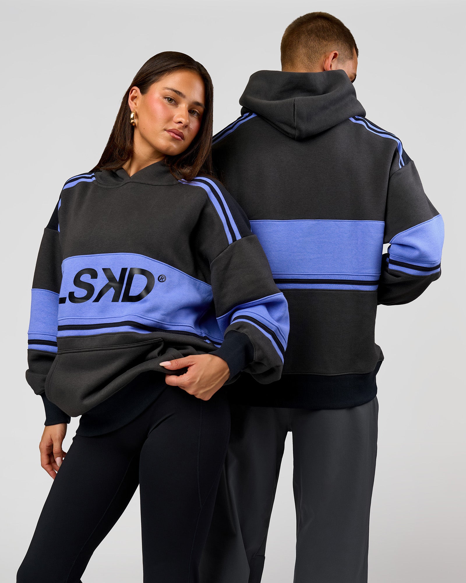 Duo wearing A-Team Oversized Hoodie - Onyx-Bluebell | Model:Bianca | Size:XS | Model:Albert | Size:M