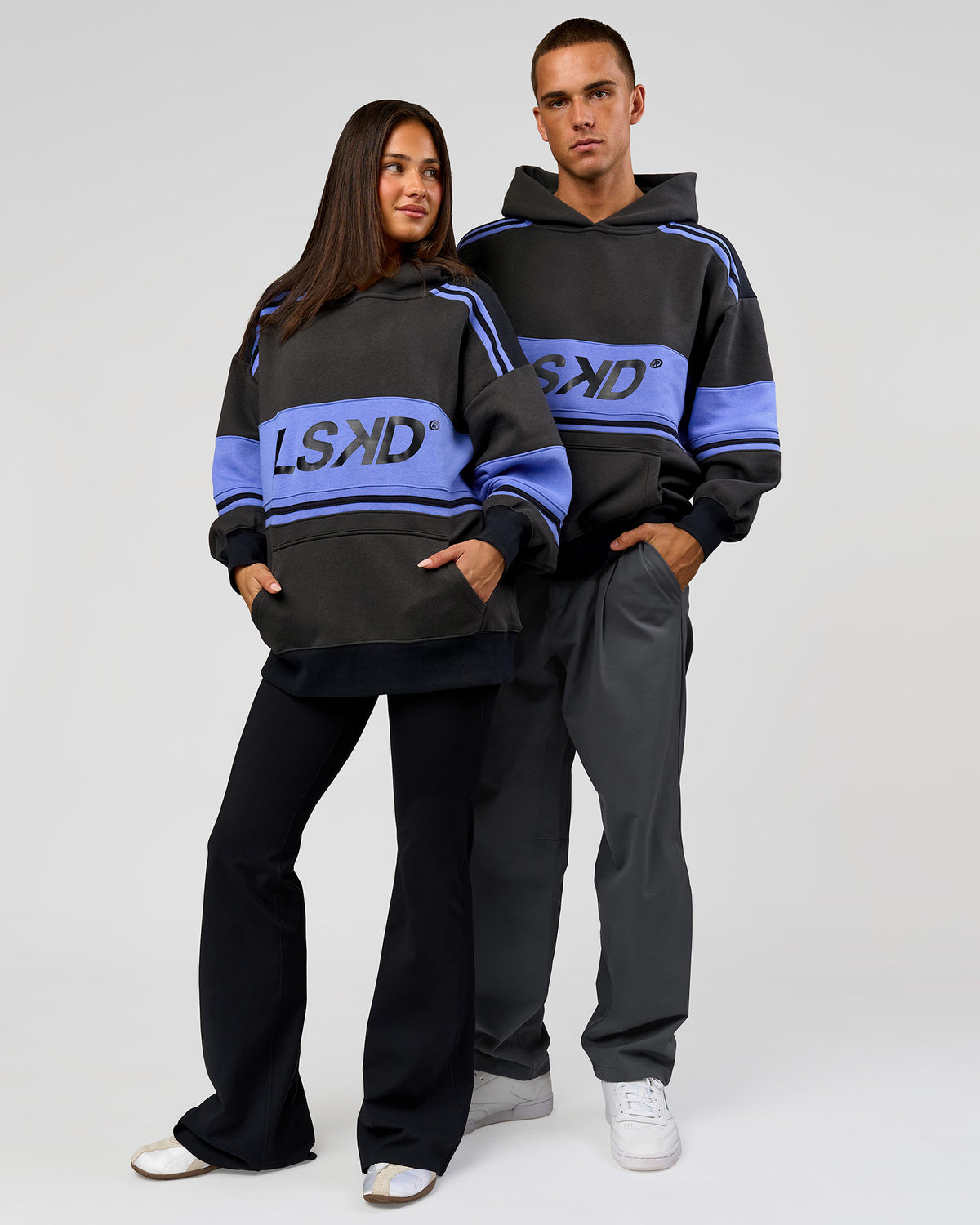Duo wearing A-Team Oversized Hoodie - Onyx-Bluebell | Model:Bianca | Size:XS | Model:Albert | Size:M