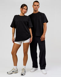 Duo wearing Tonal Legacy Heavyweight Oversized Tee - Black-Black | Model:Bianca | Size:XS | Model:Albert | Size:M | Thumbnail Index: 3