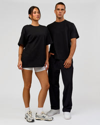 Duo wearing Tonal Legacy Heavyweight Oversized Tee - Black-Black | Model:Bianca | Size:XS | Model:Albert | Size:M | Thumbnail Index: 9