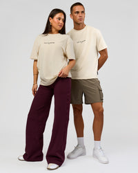 Duo wearing VS1 Enjoy The Journey FLXCotton Oversize Tee - Vanilla Bean | Model:Bianca | Size:XS | Model:Albert | Size:M | Thumbnail Index: 0