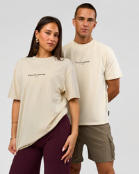 Duo wearing VS1 Enjoy The Journey FLXCotton Oversize Tee - Vanilla Bean | Model:Bianca | Size:XS | Model:Albert | Size:M | Thumbnail Index: 5