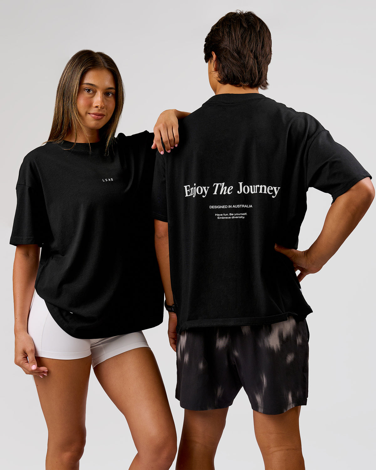 Duo wearing VS26 Journey FLXCotton Oversize Tee - Black-White | Model:Charli | Size:XS | Model:George | Size:M - view 1