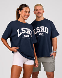 Duo wearing Varsity EST Heavyweight Oversized Tee  - Future Navy-White | Model:Charli | Size:XS | Model:Jaiden | Size:M | Thumbnail Index: 0