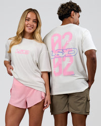 Duo wearing SoCal 26 FLXCotton Oversize Tee  - Off White-Pink Rose | Model:Issy | Size:XS | Model:Xav | Size:L | Thumbnail Index: 0
