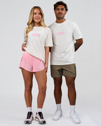 Duo wearing SoCal 26 FLXCotton Oversize Tee  - Off White-Pink Rose | Model:Issy | Size:XS | Model:Xav | Size:L | Thumbnail Index: 3