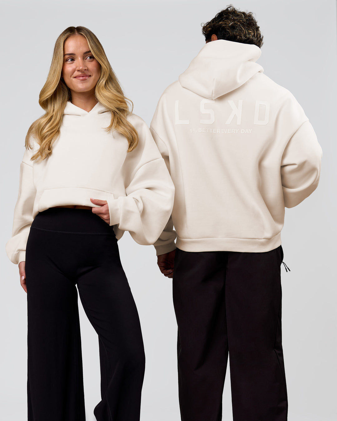 Duo wearing Tonal Legacy Boxy Hoodie - Off White-Off White | Model:Issy | Size:XS | Model:Xav | Size:L - view 1