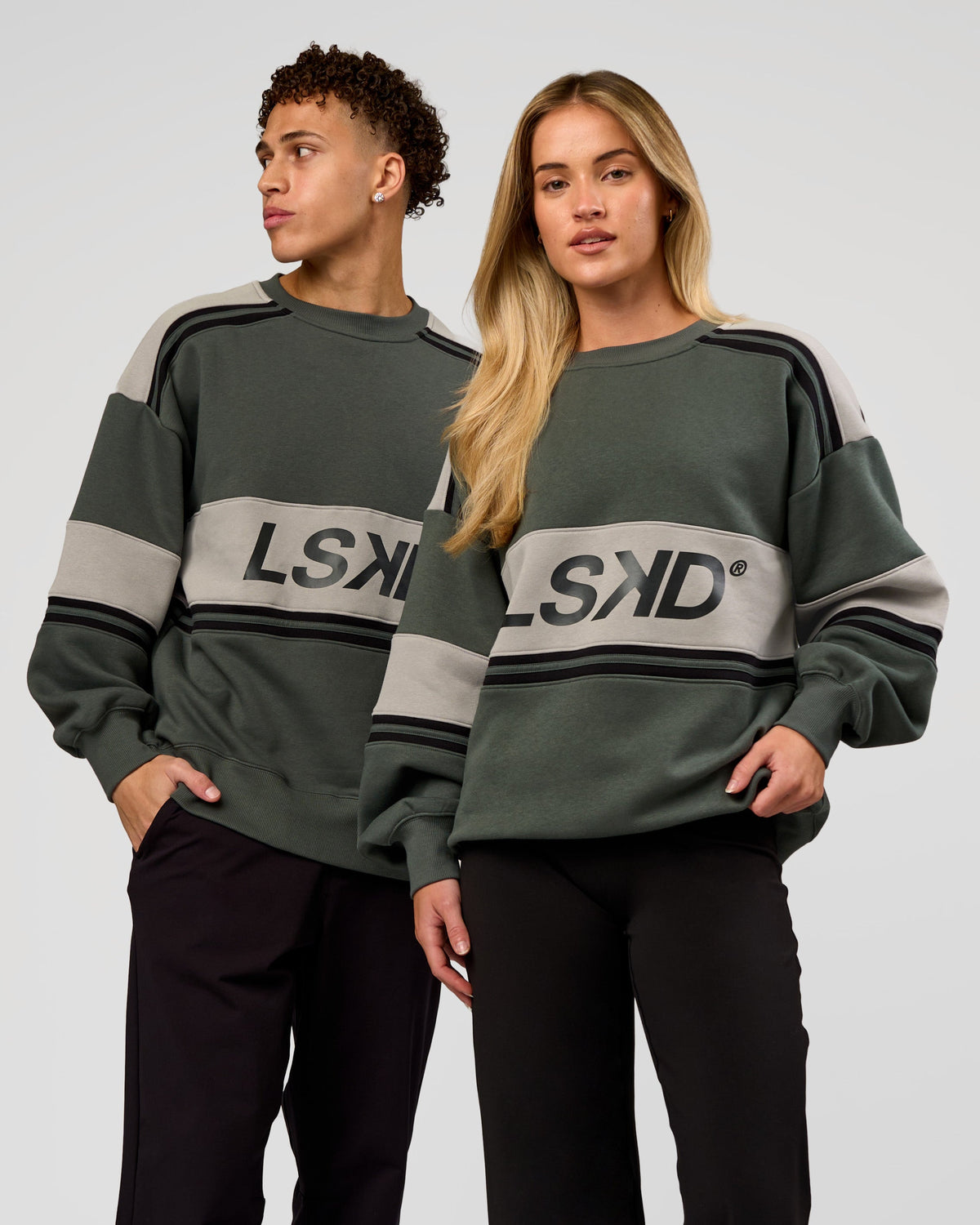 Duo wearing A-Team Sweater Oversize - Carbon Green-Alloy | Model:Issy | Size:XS | Model:Leandro | Size:M - view 1